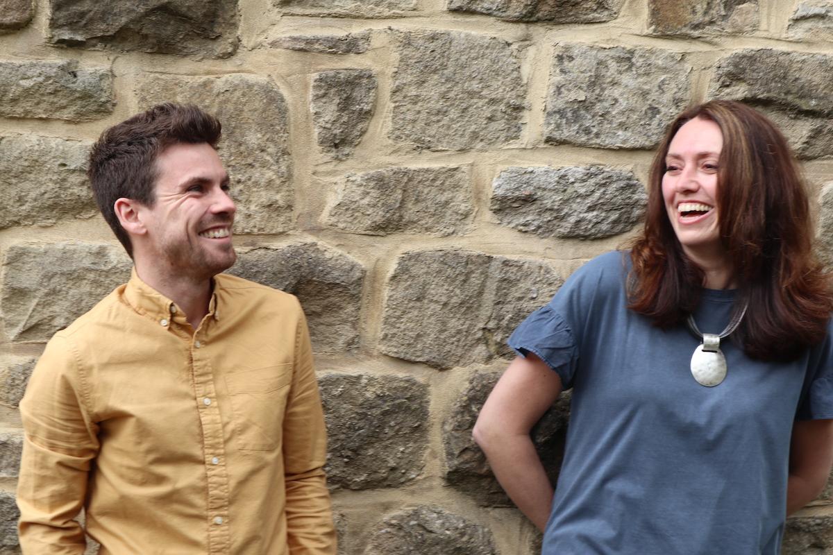 Adam and Emma laughing at something.