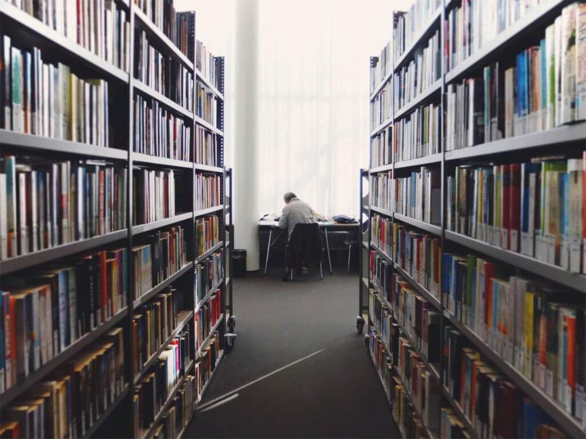 Image shows a person in a library.